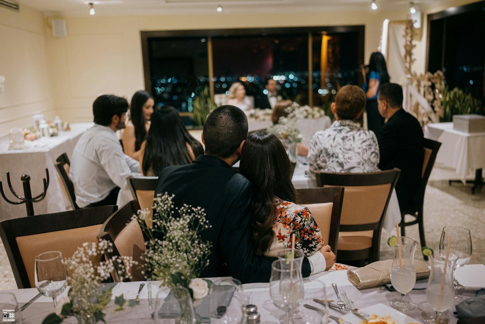 Guests gathered at tables during an evening wedding reception